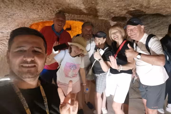 Travelers explore a Cappadocia cave on private tour from Istanbul by plane, guided visit in underground passage