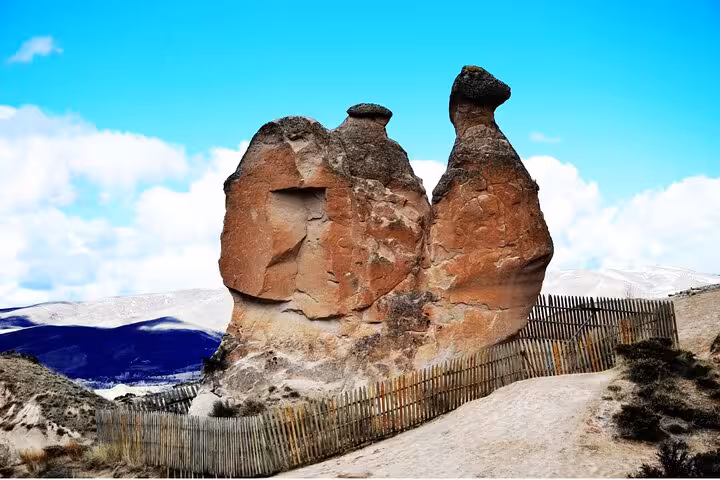 Cappadocia fairy chimney rock formation near Goreme under blue sky, featured on 2-day tour from Istanbul