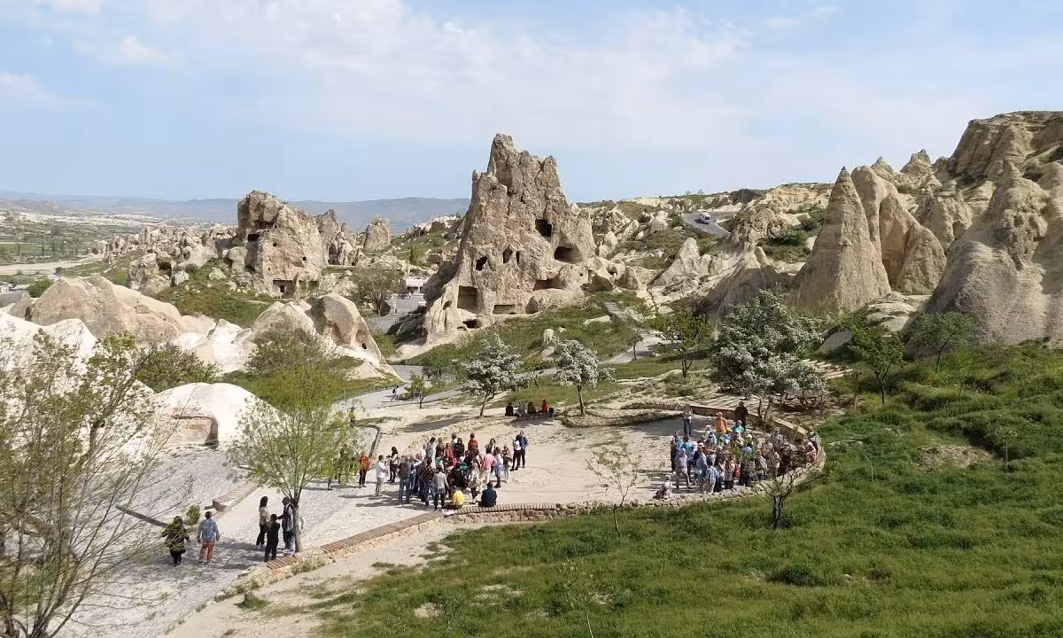 Guided group exploring Cappadocia fairy chimneys and cave homes in Goreme Valley on a 5-day Turkey vacation package