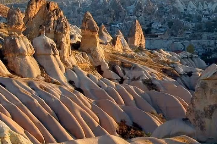 Sunlit Cappadocia fairy chimneys and rose valley ridges on a 2-day tour from Istanbul by plane