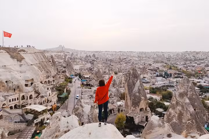 Traveler overlooking Goreme panorama and fairy chimneys in Cappadocia on a 2-day highlights tour from Istanbul