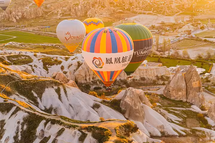Sunrise hot air balloon ride over Cappadocia fairy chimneys on 2-day 1-night Istanbul flight tour