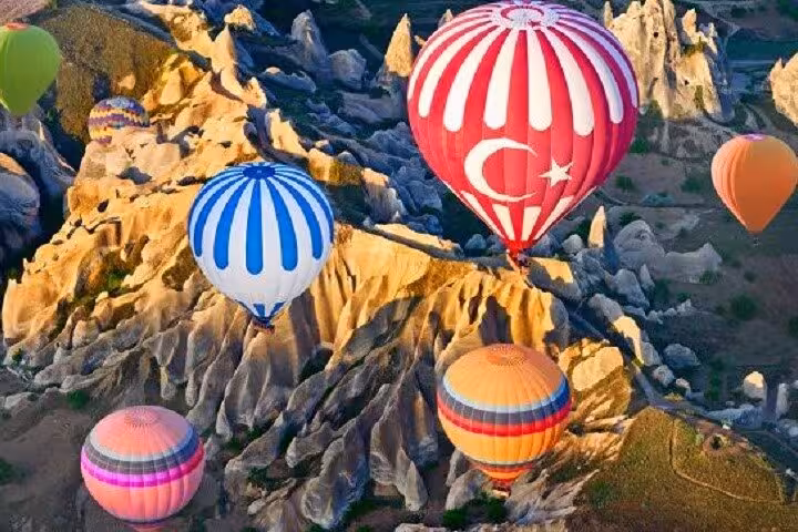 Sunrise hot air balloons over Cappadocia fairy chimneys on 5-day Ephesus Pamukkale Cappadocia tour