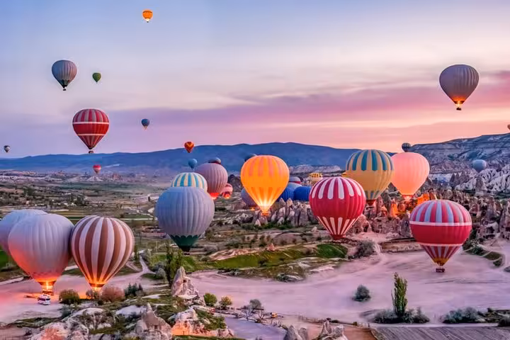 Sunrise hot air balloons over Cappadocia fairy chimneys on private tour from Istanbul to Sanliurfa