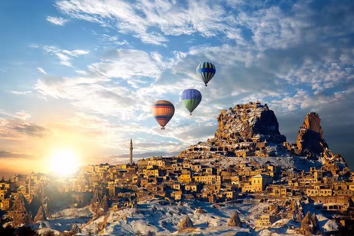 Sunrise hot air balloons over Cappadocia Goreme and Uchisar, iconic scene on private Turkey tour from Istanbul