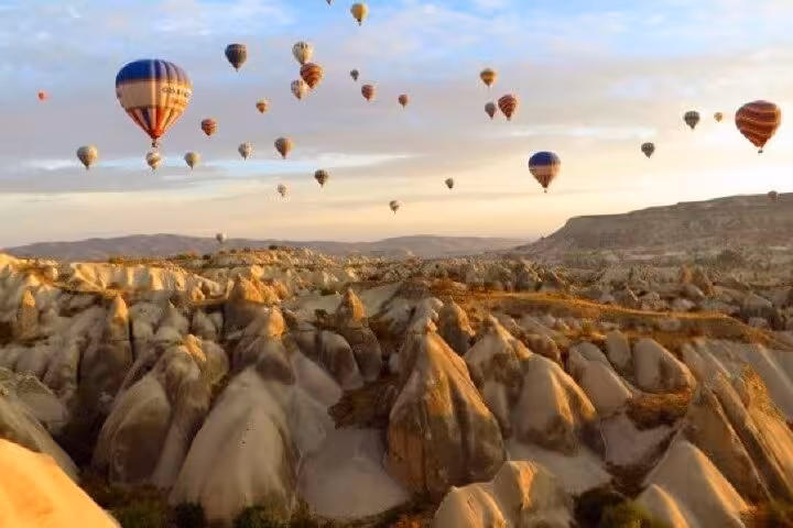 Sunrise hot air balloons over Cappadocia fairy chimneys on 8-day Turkey tour to Ephesus and Antalya
