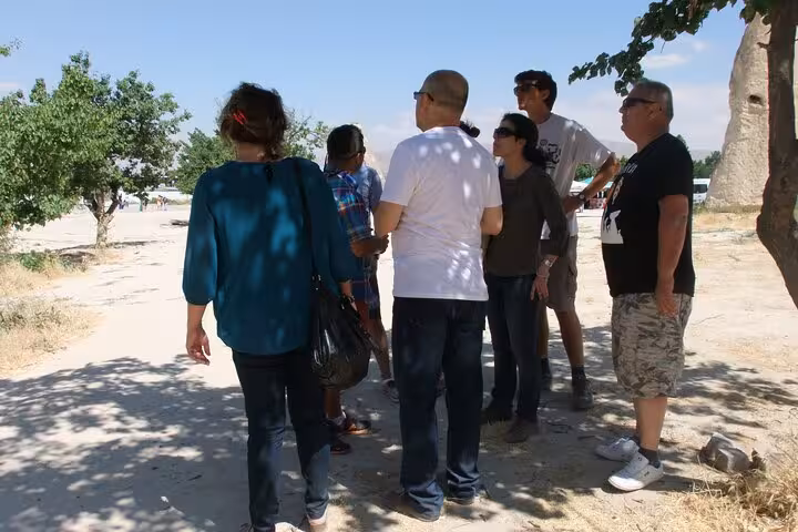 Small group listening to guide at a Cappadocia valley stop on private Istanbul to Cappadocia flight tour