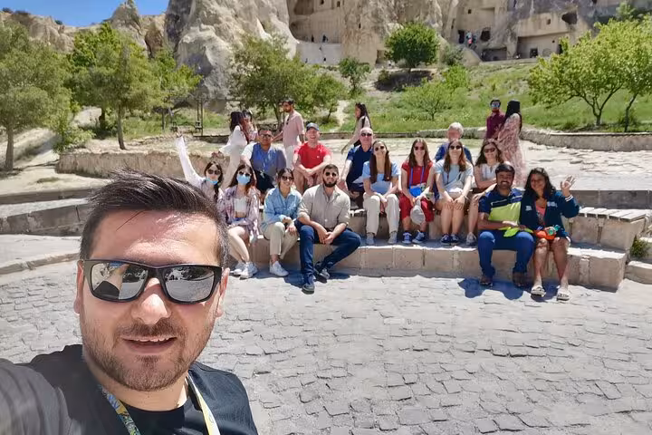 Cappadocia private tour from Istanbul by plane group photo at Göreme with fairy chimneys backdrop