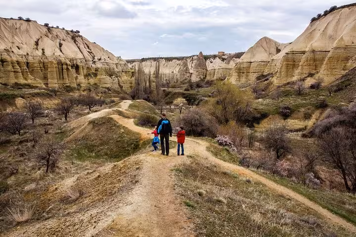 Hikers on a canyon ridge path in Cappadocia, Turkey during a 2-day private guided trekking tour
