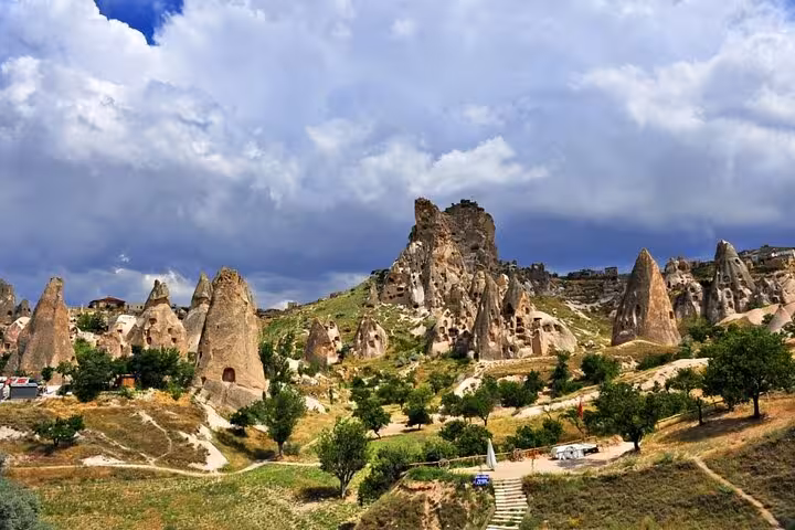 Cappadocia Red Tour panorama of Göreme fairy chimneys and rock formations under dramatic clouds, Turkey