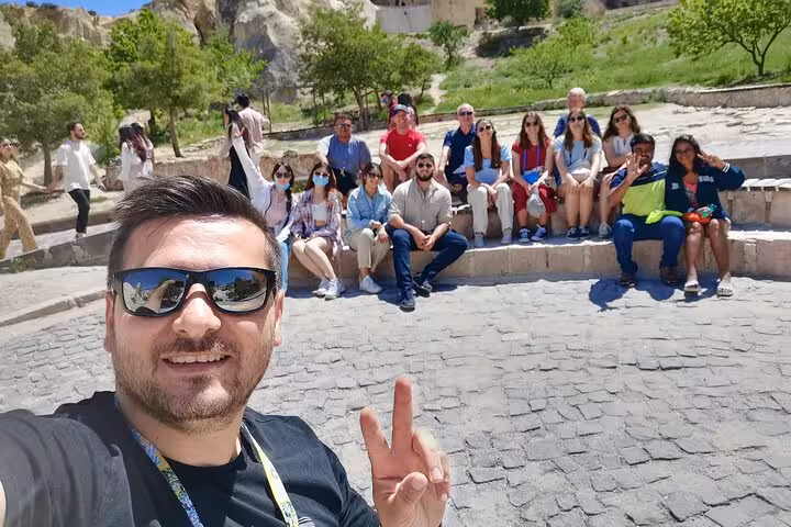 Small group selfie at Cappadocia Red Tour stop, travelers relaxing by fairy chimneys and valley views