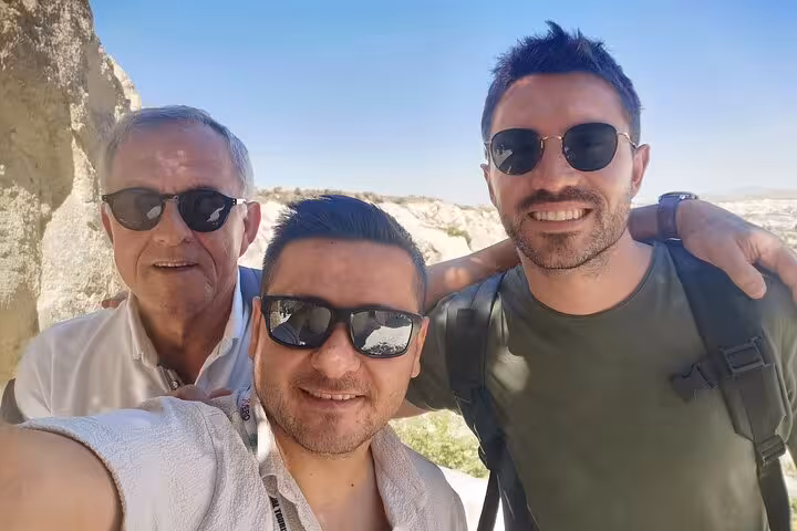 Cappadocia Red Tour small group selfie with guide at scenic viewpoint, Göreme valleys and volcanic rocks