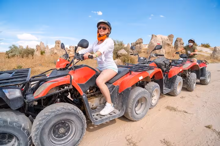 Rider on red quad bike during Cappadocia ATV tour with fairy chimneys, 2-hour off-road sunset adventure