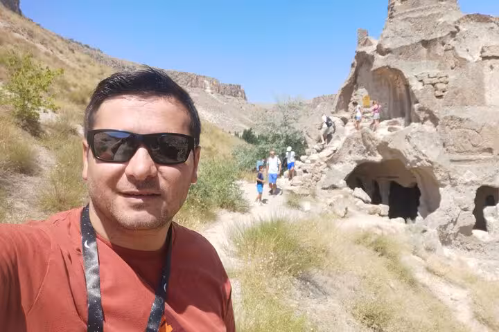 Traveler selfie at Cappadocia rock-cut caves and valley trail on business class Cappadocia tour by plane
