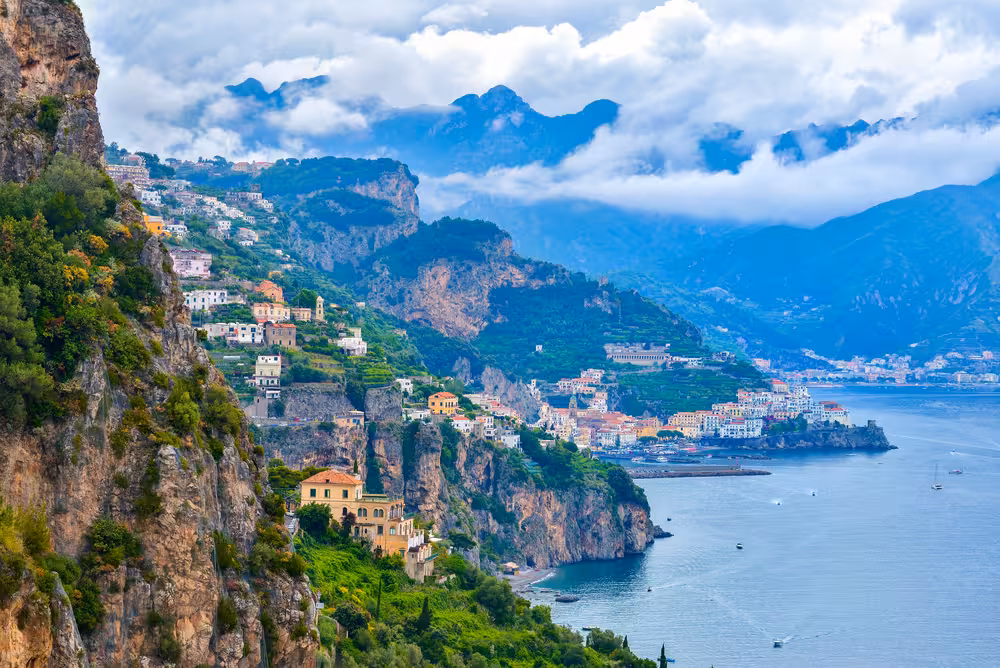 Breathtaking view of Capri's cliffs and coastal towns, showcasing the picturesque landscape of the Mediterranean region.