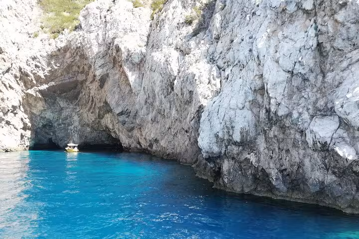Crystal-clear blue waters and rocky cliffs of Capri's coastline on an Anacapri tour boat ride.