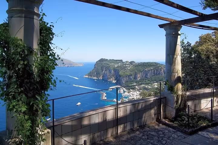 Scenic view of Capri coastline from terrace on Capri & Anacapri hydrofoil tour, showcasing azure waters and cliffs.