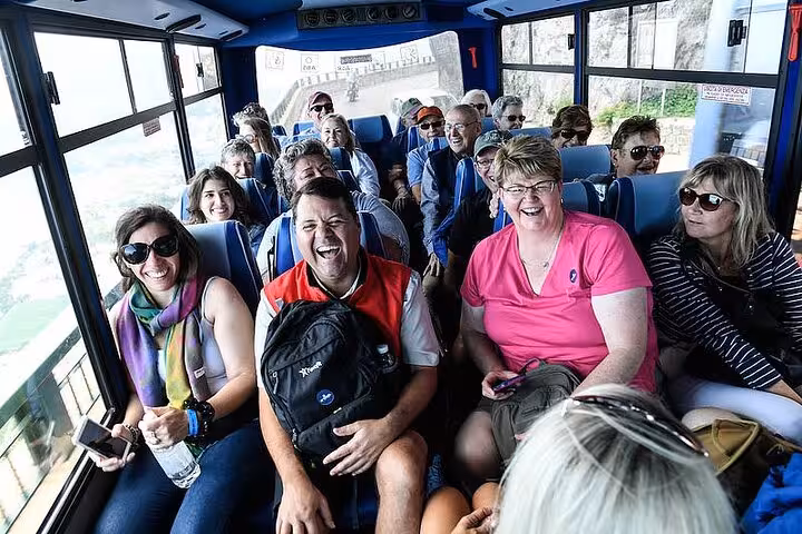 Group of tourists enjoy a lively bus ride through scenic Anacapri on the Capri & Anacapri Select tour.