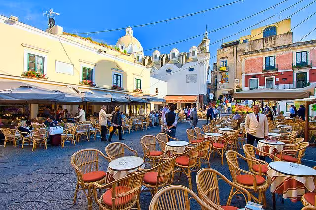 Lively Capri square with outdoor cafes and vibrant architecture, ideal for enjoying local cuisine on the Capri & Anacapri tour.