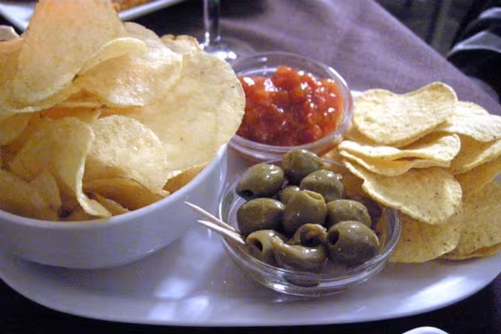 A delicious snack platter with olives, chips, and salsa served on the Capri and Blue Grotto tour from Sorrento.