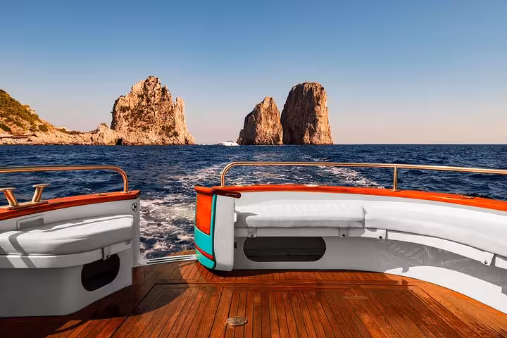 Scenic view from a boat deck approaching the iconic Faraglioni rocks on a Capri boat excursion from Sorrento.