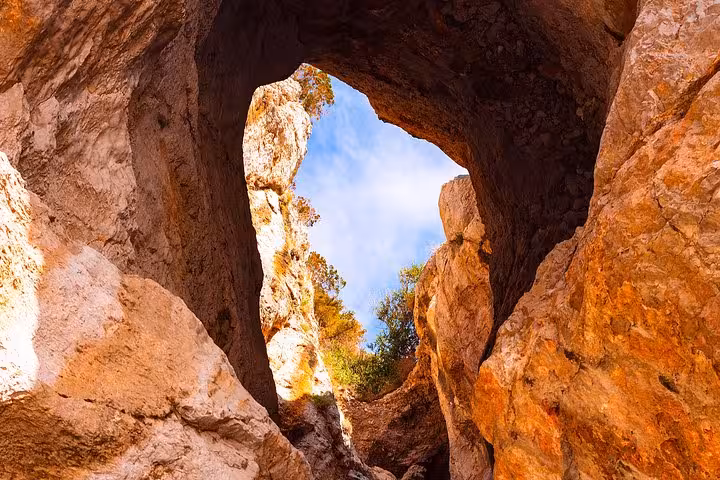 View through a natural rock arch on a Capri excursion showcasing stunning geological formations.