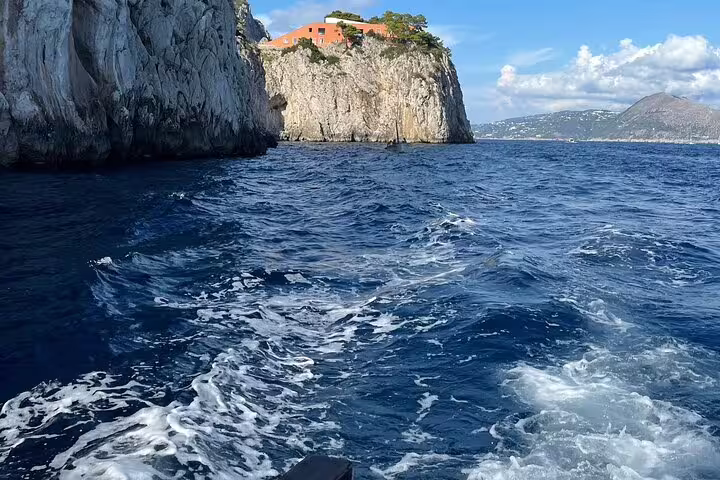 Private full-day boat tour cruising past dramatic coastal cliffs and deep blue sea, charm and freedom day