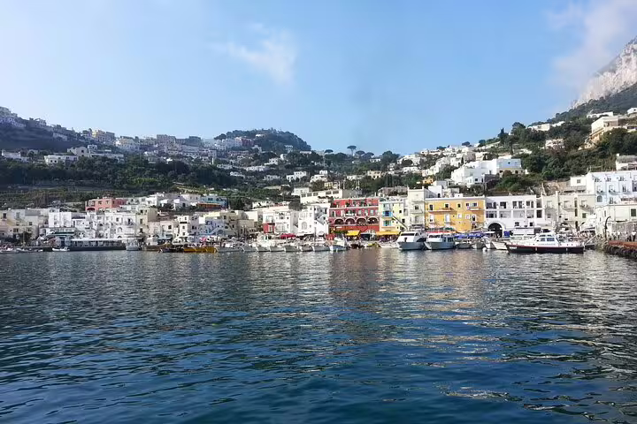 Full-day private boat tour view of Marina Grande, Capri waterfront and colorful houses from the sea