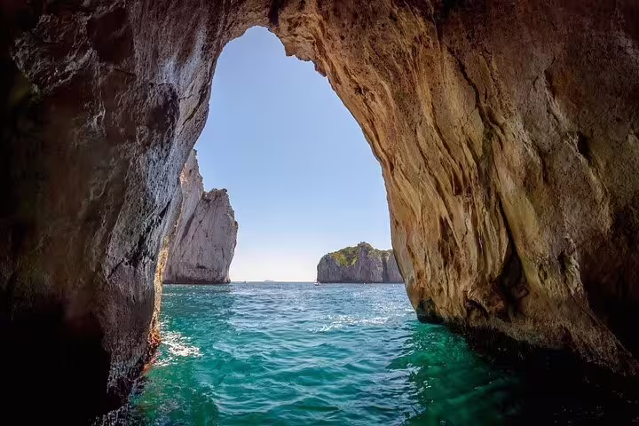 View from a sea cave to turquoise water and cliffs on a private full-day boat tour, sea day charm and freedom