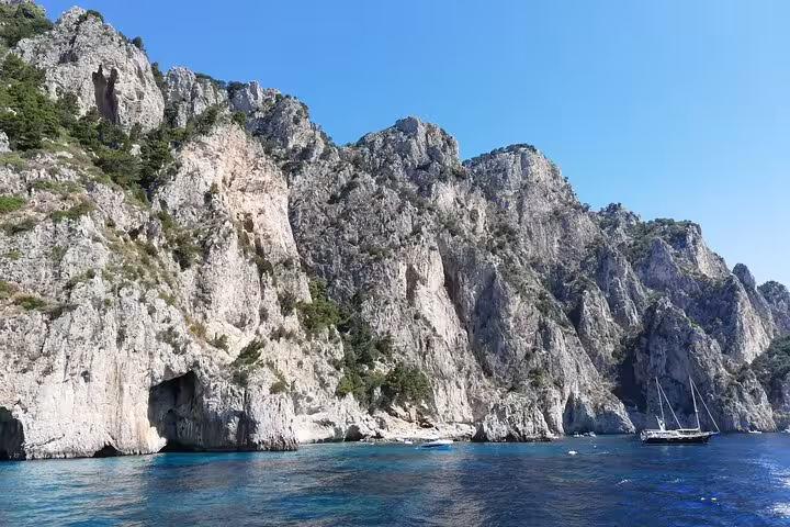 Stunning view of Capri's rugged coastline and crystal-clear waters, ideal for a private Gozzo boat tour.