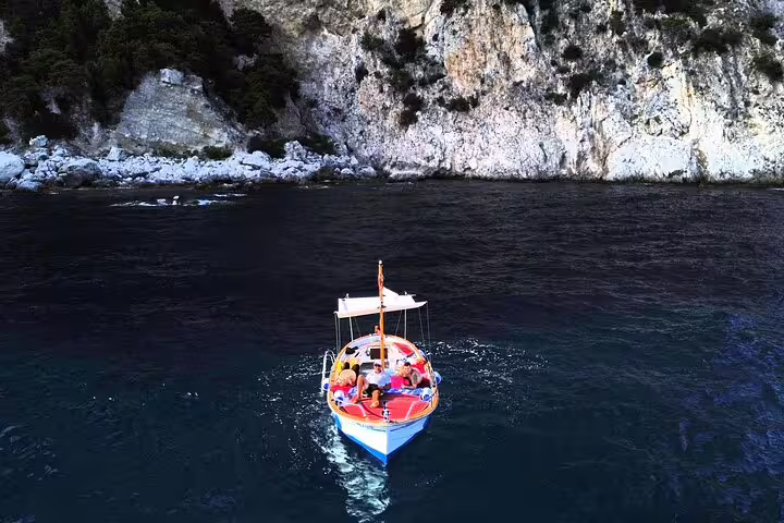 Private classic gozzo boat tour off Capri sea cliffs, small-group cruise during a 3-hour island trip