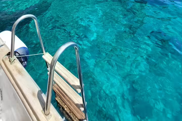 Boat ladder over turquoise Capri sea on a 3-hour private classic Gozzo tour with swim stop and island highlights