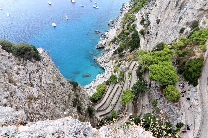 Breathtaking view of the winding coastal paths and vibrant blue waters during the Capri tour, ideal for nature lovers.