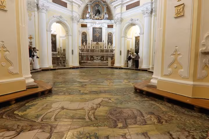 Intricate tile floor depicting animals inside a historic church in Capri, showcasing Italian craftsmanship.
