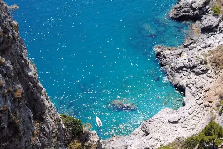 Crystal-clear turquoise waters and rocky cliffs on Capri Island, ideal backdrop for a hydrofoil journey from Naples.