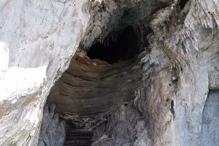 Mysterious cave entrance in Capri's cliffs, an intriguing highlight on a private Gozzo boat tour.