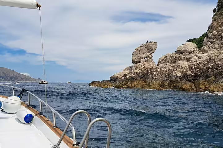 View of Capri rocky coastline from a private classic gozzo, part of a 3-hour Best of the Island boat tour