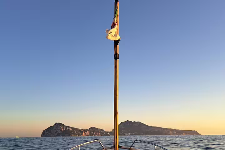 Sunset view from private boat tour bow with island horizon, full-day sea excursion for charm and freedom
