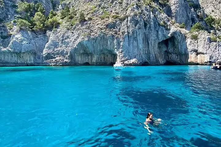 Swim in Capri’s turquoise sea by sea caves on a 3-hour private classic gozzo boat tour around the island