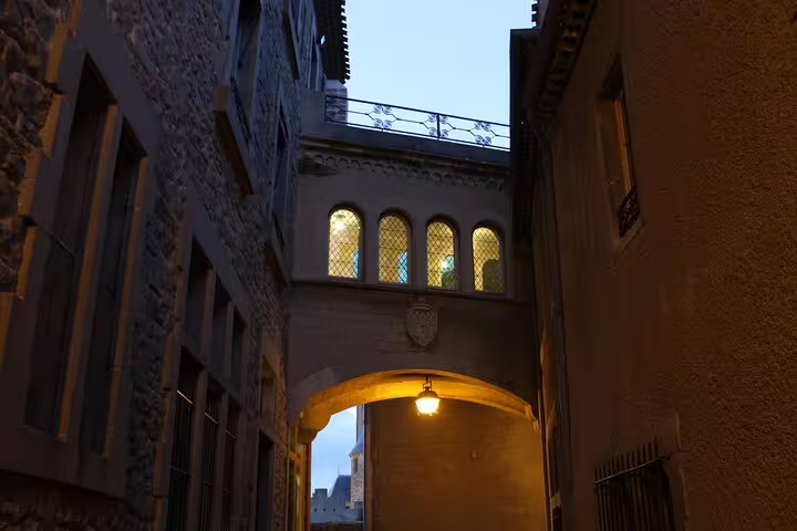 Historic archway passage in Carcassonne old town at twilight, part of a self-guided scavenger hunt tour
