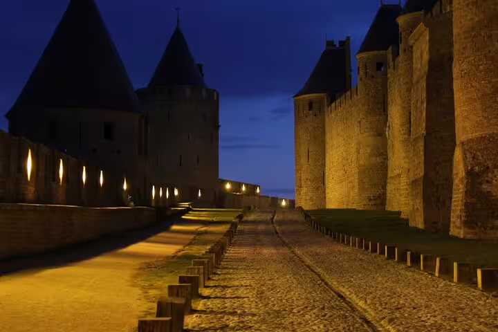 Illuminated Carcassonne castle ramparts at dusk, ideal for a self-guided scavenger hunt highlights tour