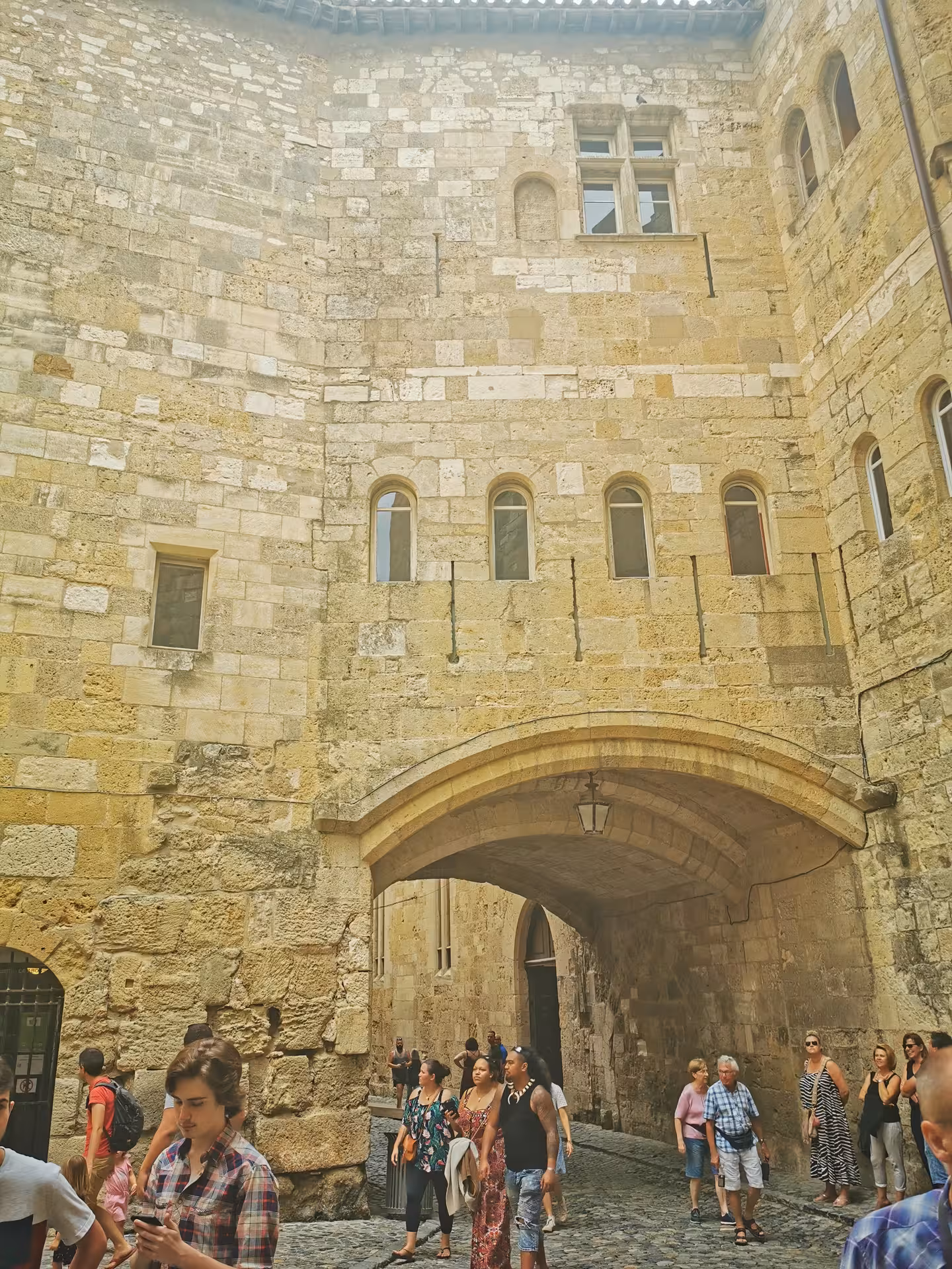 Carcassonne fortified city gate and cobblestone lane with visitors on private shore excursion from Sète