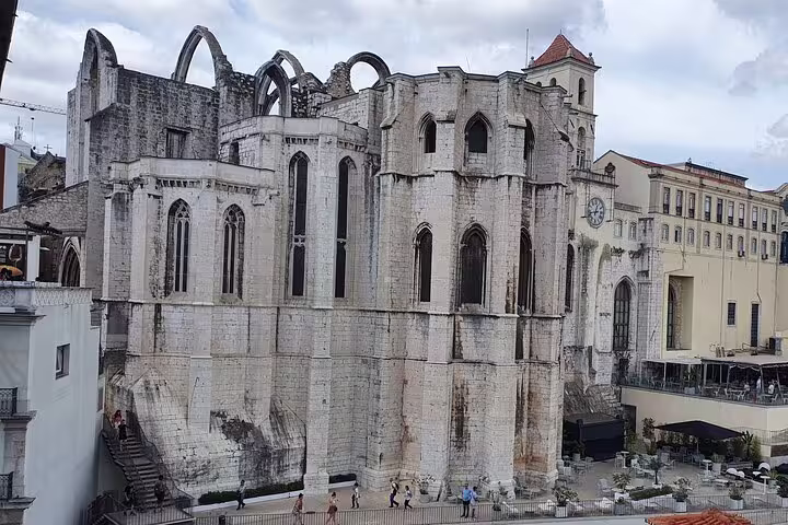 Medieval ruins of Carmo Convent in Lisbon's Old Town, showcasing Gothic architecture on a full-day tour of historical sites.