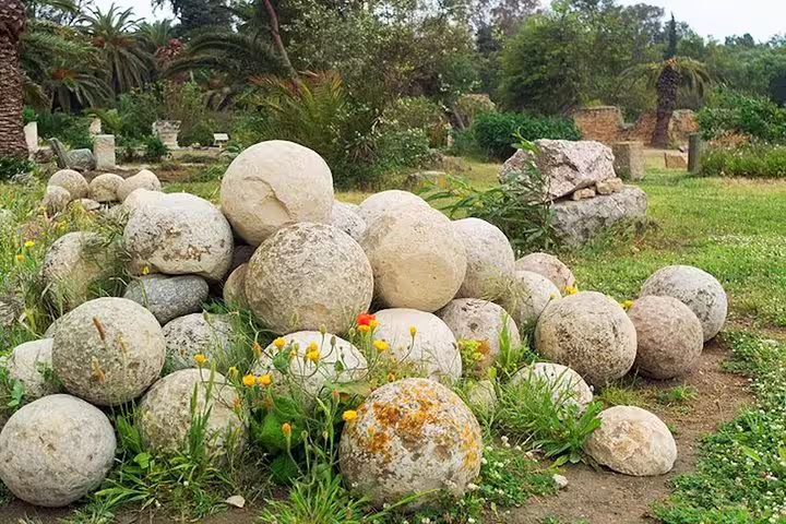 Marvel at the ancient Carthaginian stone spheres set amidst lush greenery on a fascinating half-day Carthage tour.