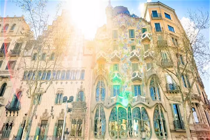 Sunlit facade of Casa Batlló in Barcelona, highlighting Gaudí's architectural brilliance on the city and wine tour.