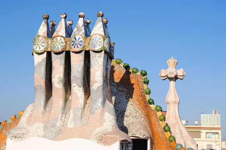 Stunning rooftop view of Casa Batlló's intricate chimneys, showcasing Gaudí's iconic architecture in Barcelona.