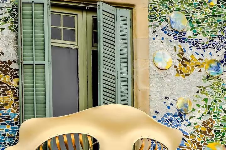 Discover a detailed view of Casa Batlló's vibrant mosaic and artistic balcony on a Barcelona private car tour.