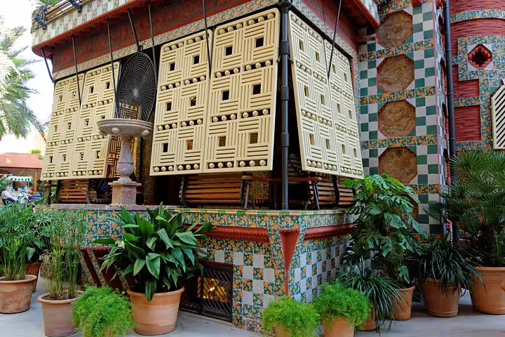 Casa Vicens facade with vibrant tiles and lush plants, a highlight of the Colonia Guell & Casa Vicens skip-the-line private tour.