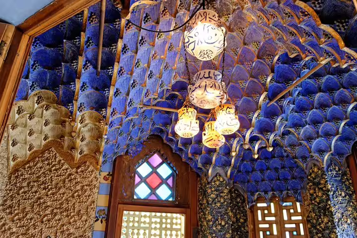 Intricate blue and gold interior of Casa Vicens showcasing ornate ceiling and stained glass, featured in Colonia Guell private tour.