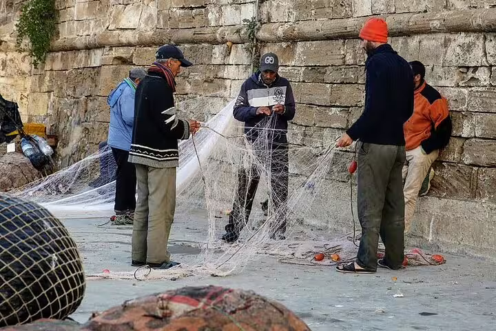 Fishermen repairing nets by the Atlantic waterfront in Casablanca, authentic stop on a private day trip through time